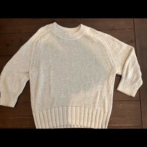 crew neck. Thick knit sweater with 3/4 sleeves.